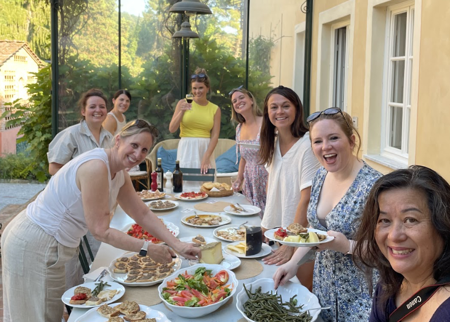 Women smiling at dinner table